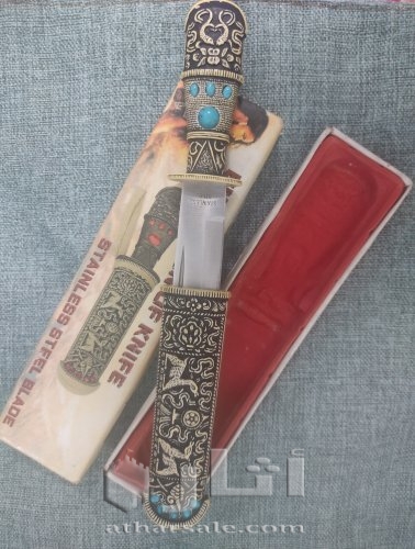 A handmade antique dagger, ivory inlaid with stones, handmade
