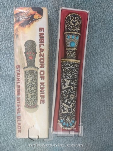 A handmade antique dagger, ivory inlaid with stones, handmade