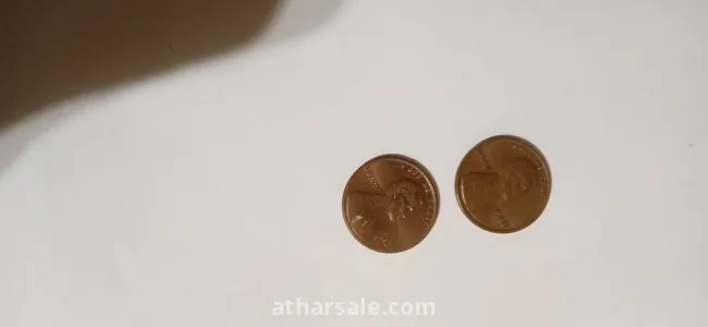 Old American coins, 1 cent release Date 1980 , another one cent release date 1982 and 5 cent release date 1988