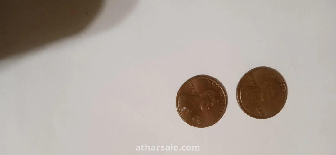 Old American coins, 1 cent release Date 1980 , another one cent release date 1982 and 5 cent release date 1988