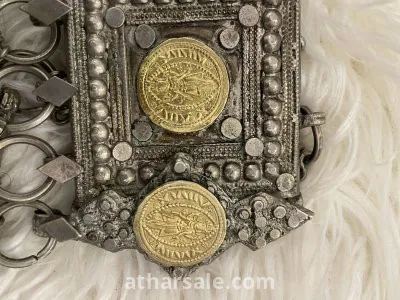 An old silver belt containing a collection of a quarter riyal dated 1354 4
