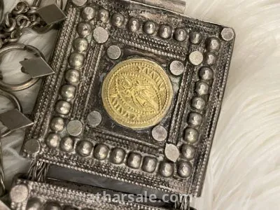 An old silver belt containing a collection of a quarter riyal dated 1354 5