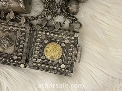 An old silver belt containing a collection of a quarter riyal dated 1354 6