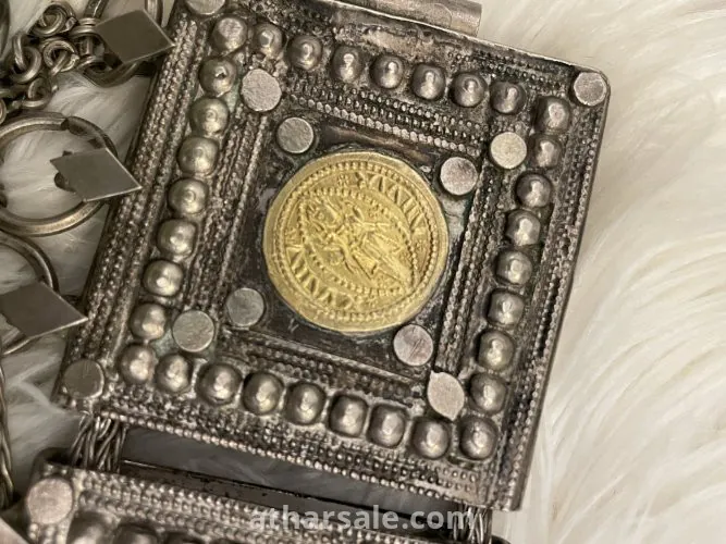 An old silver belt containing a collection of a quarter riyal dated 1354
