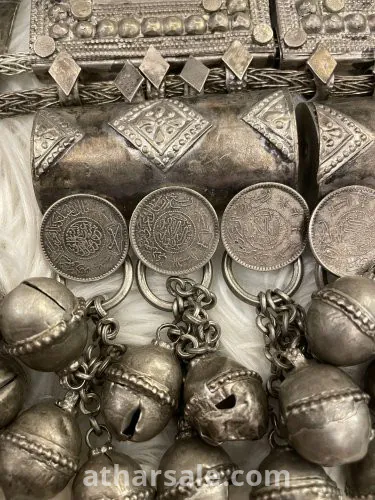 An old silver belt containing a collection of a quarter riyal dated 1354