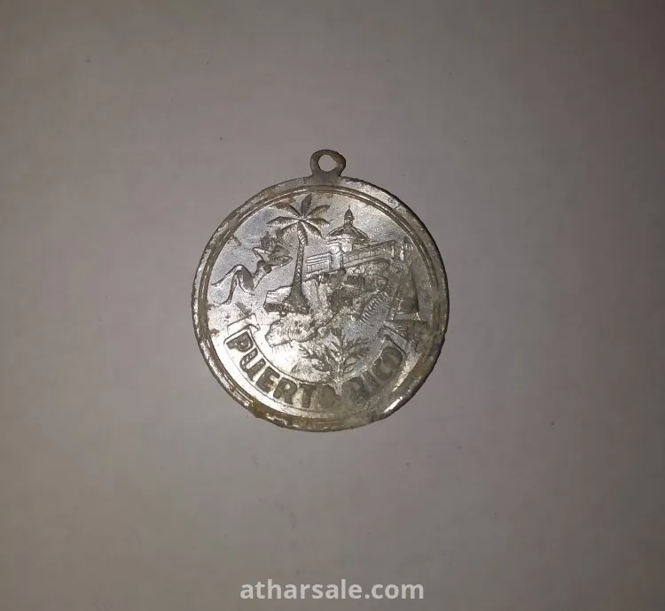 An old silver pendant and coin dating back to Puerto Rico