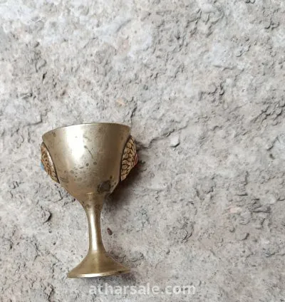 A small cup or goblet made of copper